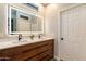 Modern bathroom with double vanity, LED mirror, and ample counter space at 42930 N Voyage Trl, Phoenix, AZ 85086