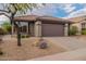 One story home with two car garage and desert landscaping at 42930 N Voyage Trl, Phoenix, AZ 85086