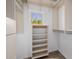 Walk-in closet with shelves, rods, and window at 6620 E Stallion Rd, Paradise Valley, AZ 85253