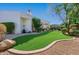 Landscaped backyard with artificial turf and a pathway at 6620 E Stallion Rd, Paradise Valley, AZ 85253
