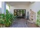 Inviting patio with double doors, fountain, and lush landscaping at 6620 E Stallion Rd, Paradise Valley, AZ 85253