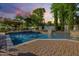 Inviting pool area with a spacious patio, gazebo, and waterfall features at 6620 E Stallion Rd, Paradise Valley, AZ 85253