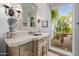 Elegant bathroom with stone vanity and courtyard view at 6620 E Stallion Rd, Paradise Valley, AZ 85253