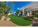 Artificial turf backyard with stone accents and a patio at 6620 E Stallion Rd, Paradise Valley, AZ 85253