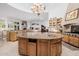 Large kitchen island with granite countertops and a built-in sink at 6620 E Stallion Rd, Paradise Valley, AZ 85253