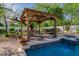 Enjoy this refreshing pool with a pergola and spa at 6620 E Stallion Rd, Paradise Valley, AZ 85253
