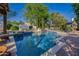 Large inviting pool with spacious patio and waterfall feature at 6620 E Stallion Rd, Paradise Valley, AZ 85253