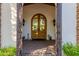 Elegant entryway with arched wood doors and wrought iron gates at 6620 E Stallion Rd, Paradise Valley, AZ 85253