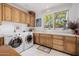 Laundry room with wood cabinets and window at 6620 E Stallion Rd, Paradise Valley, AZ 85253
