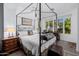 Main bedroom with a four-poster bed and access to a private patio at 6620 E Stallion Rd, Paradise Valley, AZ 85253