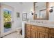 Bathroom with wooden vanity, tiled shower, and private access to the backyard at 6620 E Stallion Rd, Paradise Valley, AZ 85253