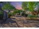 Landscaped front yard with a curved driveway, fountain, and ornate gate at 6620 E Stallion Rd, Paradise Valley, AZ 85253