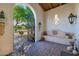 Peaceful courtyard with a stone bench and access to the backyard at 6620 E Stallion Rd, Paradise Valley, AZ 85253