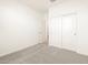 Spacious bedroom with carpet, double-door closet and access to bathroom at 8639 W Albeniz Pl, Tolleson, AZ 85353