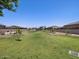 Spacious grassy area with playground in background at 8639 W Albeniz Pl, Tolleson, AZ 85353