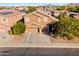 Two-story house with a large garage and landscaping, aerial view at 1542 E Chaparral Pl, Casa Grande, AZ 85122