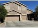 Two-story house with a three-car garage and desert landscaping at 1542 E Chaparral Pl, Casa Grande, AZ 85122