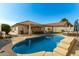 Large backyard with pool, patio, and seating at 11836 W Roanoke Ave, Avondale, AZ 85392