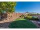 Landscaped backyard featuring a swimming pool and grassy area at 1542 E Chaparral Pl, Casa Grande, AZ 85122