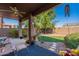 Relaxing backyard with covered patio, lush lawn, and mature trees at 1542 E Chaparral Pl, Casa Grande, AZ 85122