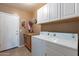 Convenient laundry room with washer, dryer, and ample storage at 1542 E Chaparral Pl, Casa Grande, AZ 85122
