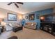 Spacious living room with two sofas, a large TV, and a fireplace at 1542 E Chaparral Pl, Casa Grande, AZ 85122