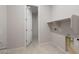 Laundry room with built-in shelving and hookups at 16728 W Saguaro Park Ln, Surprise, AZ 85387