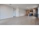 Open living room with tile floor and kitchen views at 40040 W Bravo Dr, Maricopa, AZ 85138