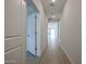 Bright hallway with tile flooring and access to multiple rooms at 40040 W Bravo Dr, Maricopa, AZ 85138