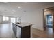 Kitchen island with granite countertop and stainless steel dishwasher at 40040 W Bravo Dr, Maricopa, AZ 85138