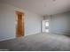 Large bedroom with carpet and access to a bathroom and another room at 40040 W Bravo Dr, Maricopa, AZ 85138