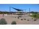 Community playground with shade structures and play equipment at 40040 W Bravo Dr, Maricopa, AZ 85138