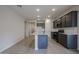 Modern kitchen featuring granite countertops, dark cabinetry, and stainless steel appliances at 40040 W Bravo Dr, Maricopa, AZ 85138