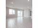 Living room with tile flooring, sliding doors to backyard at 40040 W Bravo Dr, Maricopa, AZ 85138