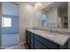 Double vanity bathroom with granite countertops and a large mirror at 40040 W Bravo Dr, Maricopa, AZ 85138