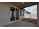 Covered patio with sliding glass doors leading to the backyard at 40040 W Bravo Dr, Maricopa, AZ 85138