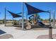 Modern playground with shade structures and play equipment at 40040 W Bravo Dr, Maricopa, AZ 85138