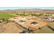 Aerial view of five new homes under construction in a rural setting at 18083 W Amber Dr, Goodyear, AZ 85338