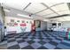 Large garage with ample storage, workbenches and checkerboard flooring at 331 W Dundy St, San Tan Valley, AZ 85143