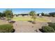 Large backyard with putting green, gravel landscaping, and mature trees at 331 W Dundy St, San Tan Valley, AZ 85143
