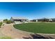 Expansive backyard with circular lawn and patio at 331 W Dundy St, San Tan Valley, AZ 85143