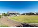 Spacious backyard features a putting green and a large grassy area at 331 W Dundy St, San Tan Valley, AZ 85143