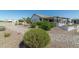 Landscaped backyard with gravel, desert plants, and a covered patio at 331 W Dundy St, San Tan Valley, AZ 85143