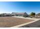 House exterior with three-car garage and desert landscaping at 331 W Dundy St, San Tan Valley, AZ 85143