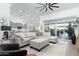Bright living room featuring a large sectional sofa and sliding glass doors at 331 W Dundy St, San Tan Valley, AZ 85143