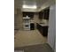 Basic kitchen with white appliances and dark cabinets at 1607 W Shangri La Rd, Phoenix, AZ 85029