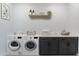 Convenient laundry room with washer, dryer, and cabinets at 18083 W Amber Dr, Goodyear, AZ 85338