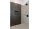 Modern shower with dark linear tile and built-in niche at 18083 W Amber Dr, Goodyear, AZ 85338