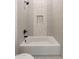 Bathroom with a bathtub and hexagon tile feature wall at 18083 W Amber Dr, Goodyear, AZ 85338