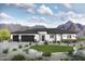 Modern single story house with a two car garage and desert landscaping at 18083 W Amber Dr, Goodyear, AZ 85338